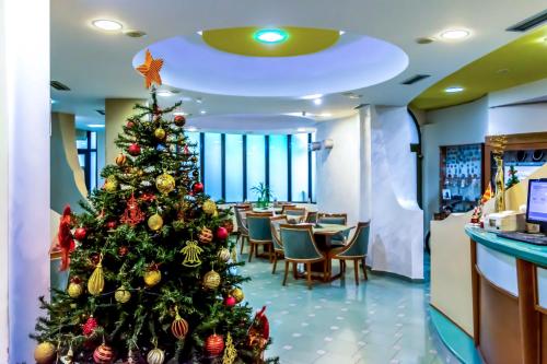 a christmas tree in the lobby of a restaurant at Hotel Cingo in Ohrid
