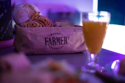 a bag of bread and a glass of orange juice at 31A Urban Stays in Norwich