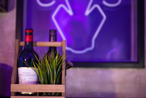two bottles of wine and a plant in a wooden crate at 31A Urban Stays in Norwich