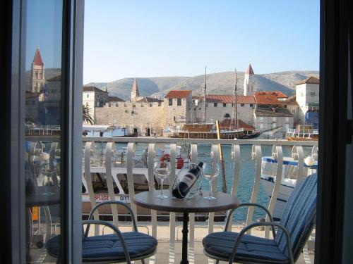 a table and chairs with a view of the water at Villa Tudor in Trogir