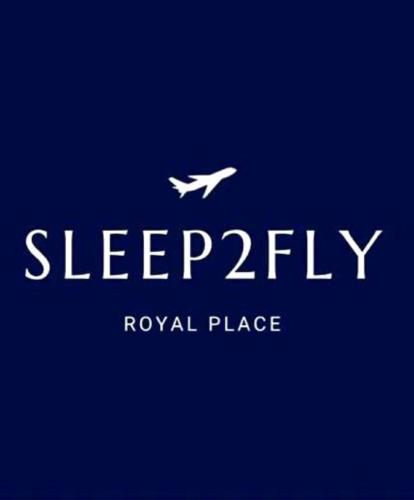 a white plane is flying in the sky at Sleep2Fly Hamburg-Airport in Hamburg