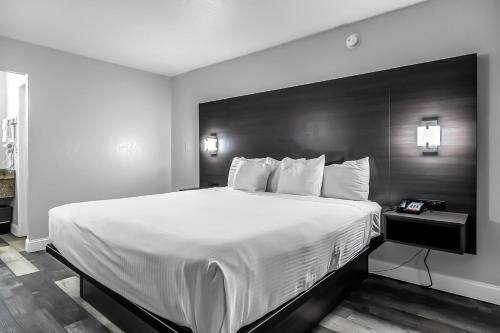 a large white bed in a hotel room at SureStay Hotel by Best Western Oklahoma City West in Oklahoma City