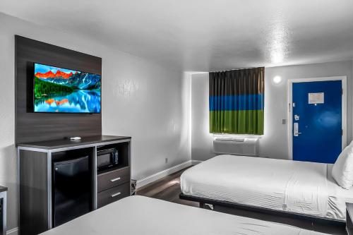 a hotel room with two beds and a tv at SureStay Hotel by Best Western Oklahoma City West in Oklahoma City
