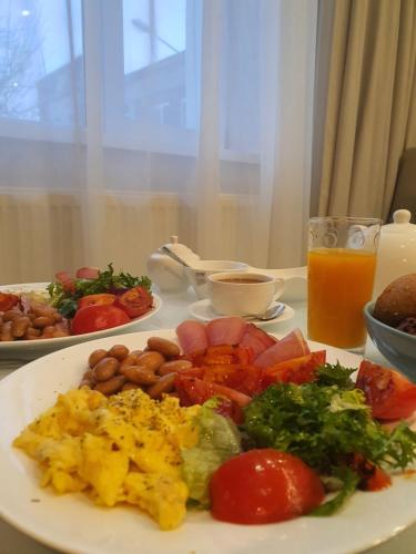a plate of food with eggs and vegetables on a table at Citylife Boutique Hotel in Kharkiv