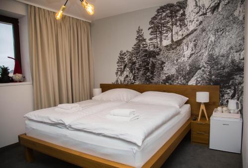 Säng eller sängar i ett rum på Snowland Apartmány
