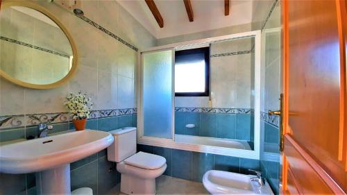 a bathroom with a sink toilet and a mirror at Villa Costa in Moraira