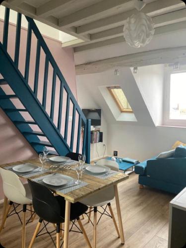 une salle à manger avec une table et un escalier dans l'établissement Gite la Bancloque, à Compiègne
