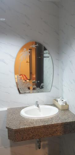a bathroom with a sink and a mirror at Sunview Place in Pattaya Central