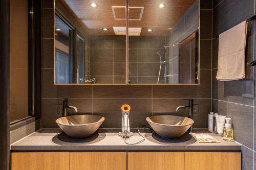 two bowls on a counter in a bathroom at Kyoto Hiyori Mitake 日和御竹 in Kyoto
