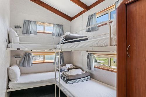 a room with two bunk beds in a trailer at Murray River Holiday Park in Moama