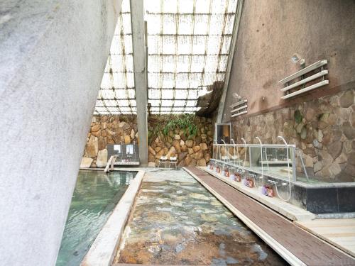 a large pool of water in a building with a pool at HOTEL SHIRAHAMAKAN in Shirahama