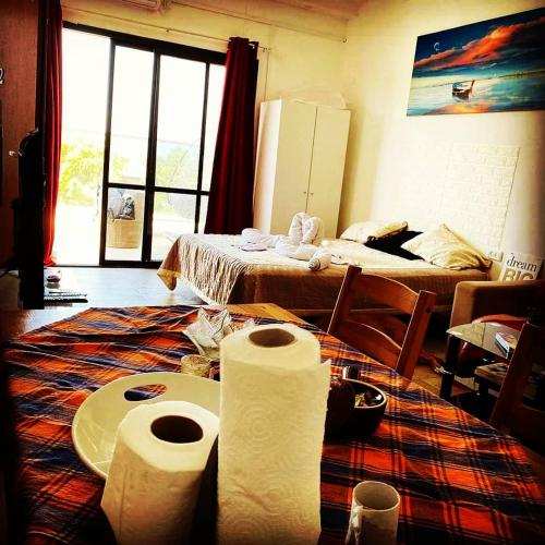 a room with two beds and two rolls of paper towels at comft suite Nahariyya in Nahariyya
