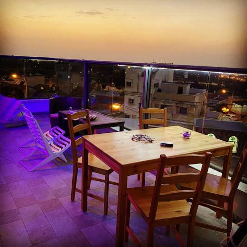 a table and chairs on top of a balcony at comft suite Nahariyya in Nahariyya