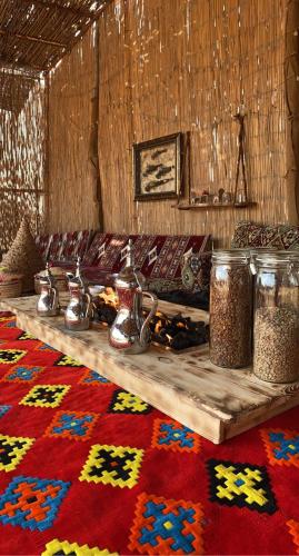 a room with a table with tea pots and a rug at Farm Lebanon in Abu Dhabi