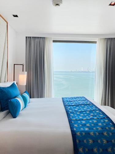 a bedroom with a large bed with a large window at InterContinental Marine Drive Mumbai by IHG in Mumbai