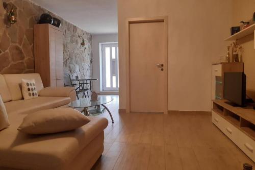 a living room with a couch and a table at Apartmant Angel Wings in Omiš