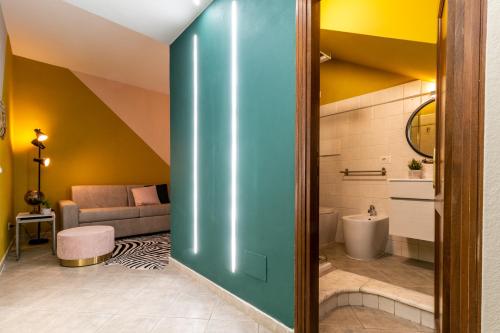 a bathroom with a green pivot door in a room at BOUTIQUE APARTMENTS COLLECTION-GENIO RIBELLE in Sassari