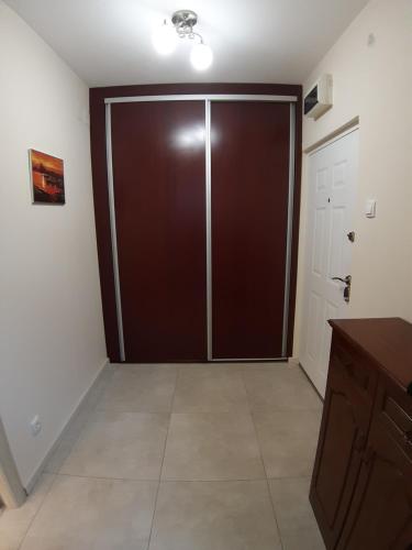 a large brown sliding door in a room at Danube Blue 2 in Belgrade