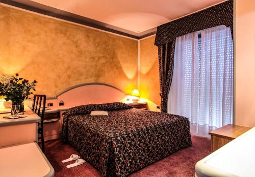 Postel nebo postele na pokoji v ubytování Hotel Grazia Deledda
