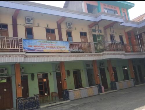 un edificio con un cartello sul lato di Hotel Surya Utama - Syariah a Probolinggo