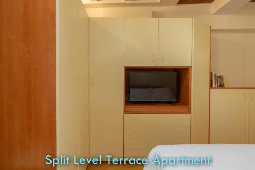a bedroom with a tv in a built in cabinet at BolognaRoomscom - Santo Stefano Apartments in Bologna