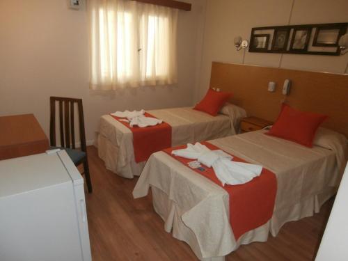 a hotel room with two beds with towels on them at Hotel Alma di Mare in Mar del Plata