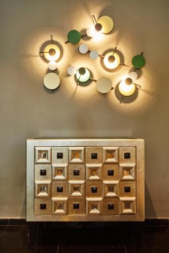 a wine rack with lights on a wall at ibis budget Singapore Bugis in Singapore