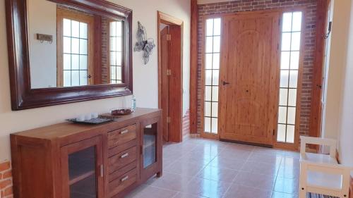 a bathroom with a wooden dresser and a mirror at Casa las Estrellas in Agua de Bueyes