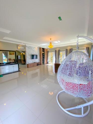 a large glass ball is hanging in a room at AL Marina Resort in Puncak