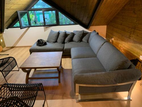 a living room with a couch and a table at Il était une fois sous l’arbre in Saint-André