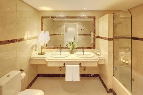 a bathroom with a sink and a shower and a toilet at Vasari Resort in Marbella