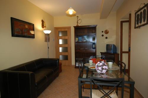 ein Wohnzimmer mit einem Sofa und einem Tisch in der Unterkunft L'Antipapa in Fondi