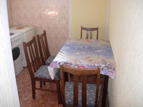 a kitchen with a table and chairs with a table and a table and chairsuggest at Rooms & Apartments Anka in Bar