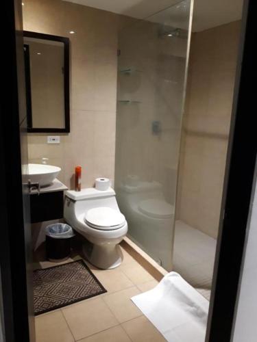 a bathroom with a toilet and a shower and a sink at Playa Blanca Town Center B in Playa Blanca