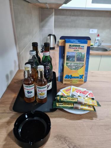 a table with bottles of beer and a box of cigarettes at Monix Palace Zlatibor in Zlatibor