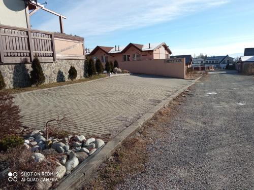 a cobblestone driveway in front of a house at Apartman Baska in Veľký Slavkov