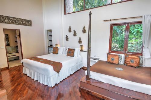 a bedroom with two beds and a window at Khanom Hill Resort in Khanom