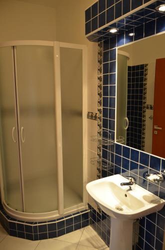 a bathroom with a shower and a sink and a mirror at Eurohotel in Karlovy Vary