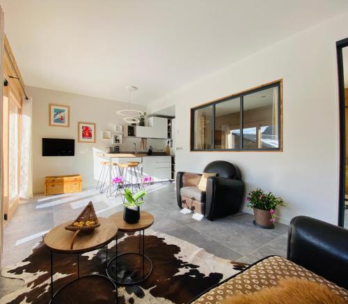 a living room with a couch and a table at CHALET LYOBA in Le Grand-Bornand