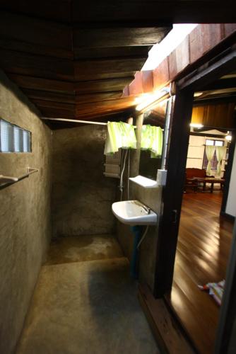 a small bathroom with a sink and a mirror at Ocean front 2br 107sqm house - Panorama Sea View in Laem Ngop