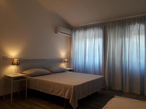 a bedroom with a bed and a window at Fontanarossa Airport Sleep and Travel in Catania