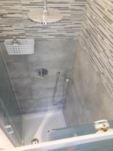 a bathroom with a shower and a bath tub at Fontanarossa Airport Sleep and Travel in Catania