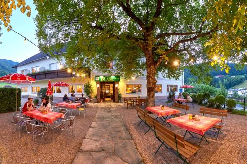 a restaurant with tables and chairs in front of a building at Gasthof BLASL Margaretha in Losenstein