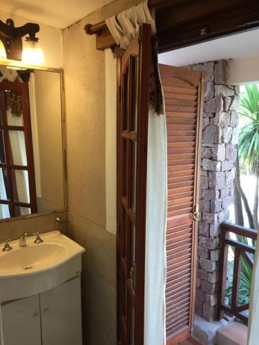a bathroom with a sink and a mirror at Hotel Gloria in Santa Rosa de Calamuchita