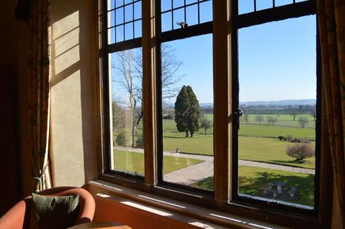 a window with a view of a green field at Kincraig Castle Hotel in Invergordon