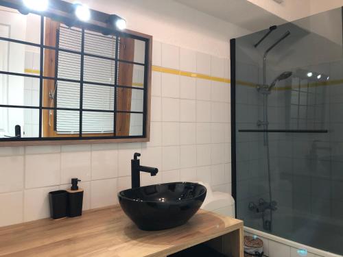 a bathroom with a black sink and a shower at Petite Marmotte in Saint-Gervais-les-Bains