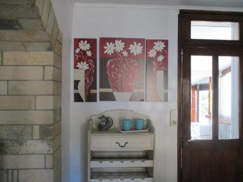 a room with a dresser and paintings on the wall at GÏTE LE CONFLUENT in Vireux-Molhain