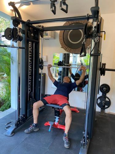 a man in a gym performing a barbell deadlift at Casa Da Praia in Candolim