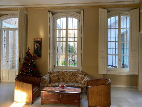 a living room with a couch and a christmas tree at HOTEL CASABLANCA BOUTIQUE in Linares