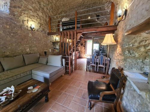 a living room with a couch and a staircase at Pyrgos 1869 with Private Pool in Gythio